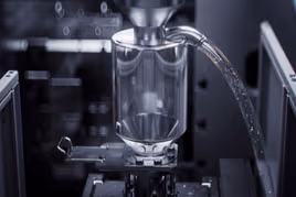 Metal chips moving through thixomolding machine
