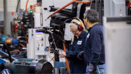 Dynacast employees checking for quality assurance
