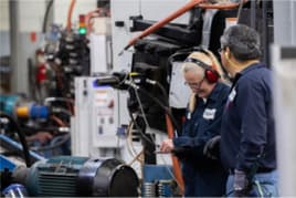 Dynacast employees checking for quality assurance