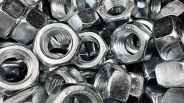 Shiny die cast nuts in a pile