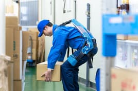 Worker wearing an exoskeleton to help with manual labor