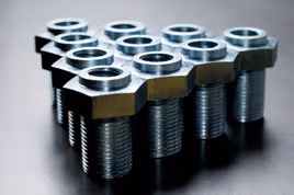Die cast nuts and bolts in a triangle pattern